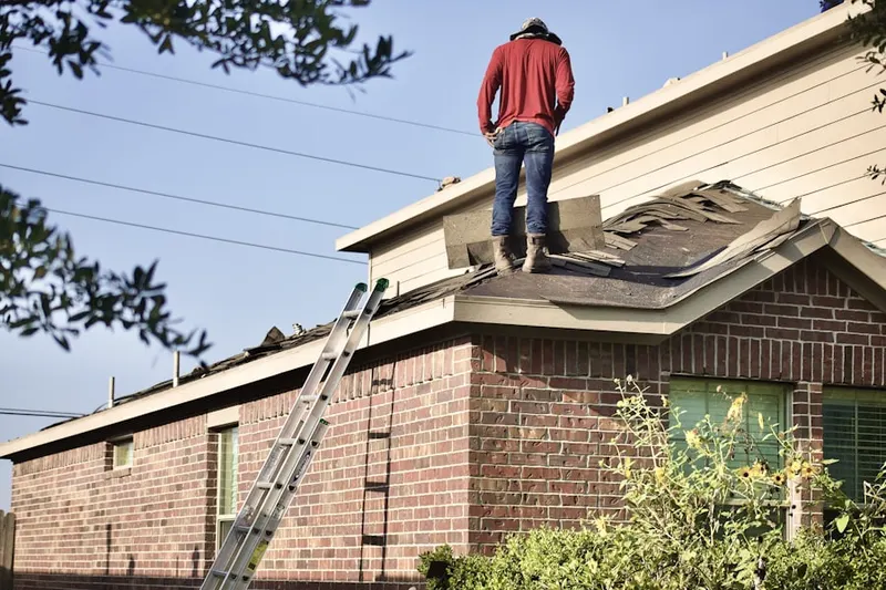 Professional roofer working on a residential roof in Evergrene